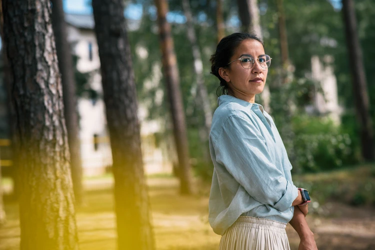 Frau steht im wald und schaut in die ferne